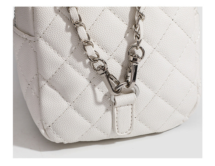 Compact diamond-quilted mini backpack handbag with silver-tone chain straps and turn-lock front pocket, detail view 11