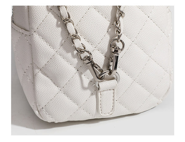 Compact diamond-quilted mini backpack handbag with silver-tone chain straps and turn-lock front pocket, detail view 11