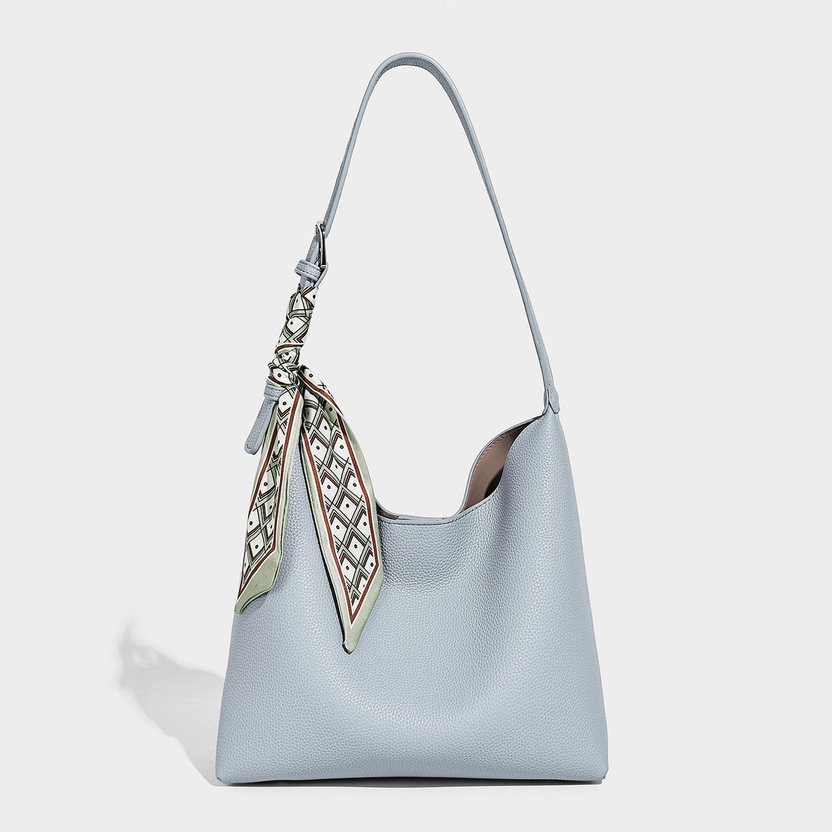 Soft slouchy hobo shoulder bag in pebbled matte finish with slim strap, silver-tone ring hardware, and knotted printed scarf