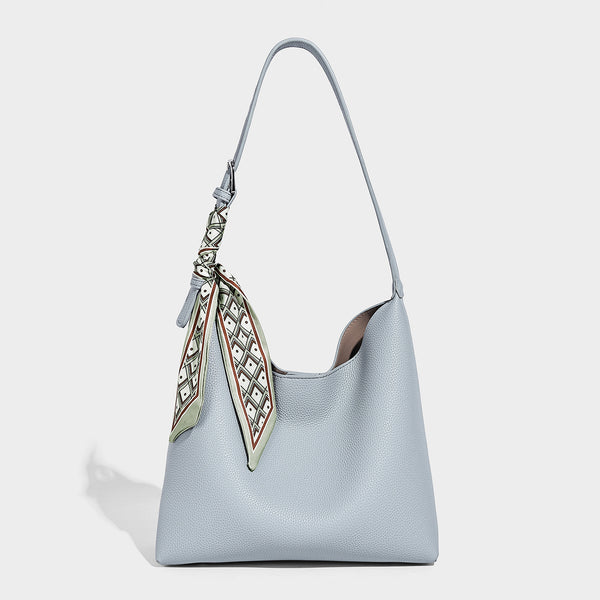 Soft slouchy hobo shoulder bag in pebbled matte finish with slim strap, silver-tone ring hardware, and knotted printed scarf