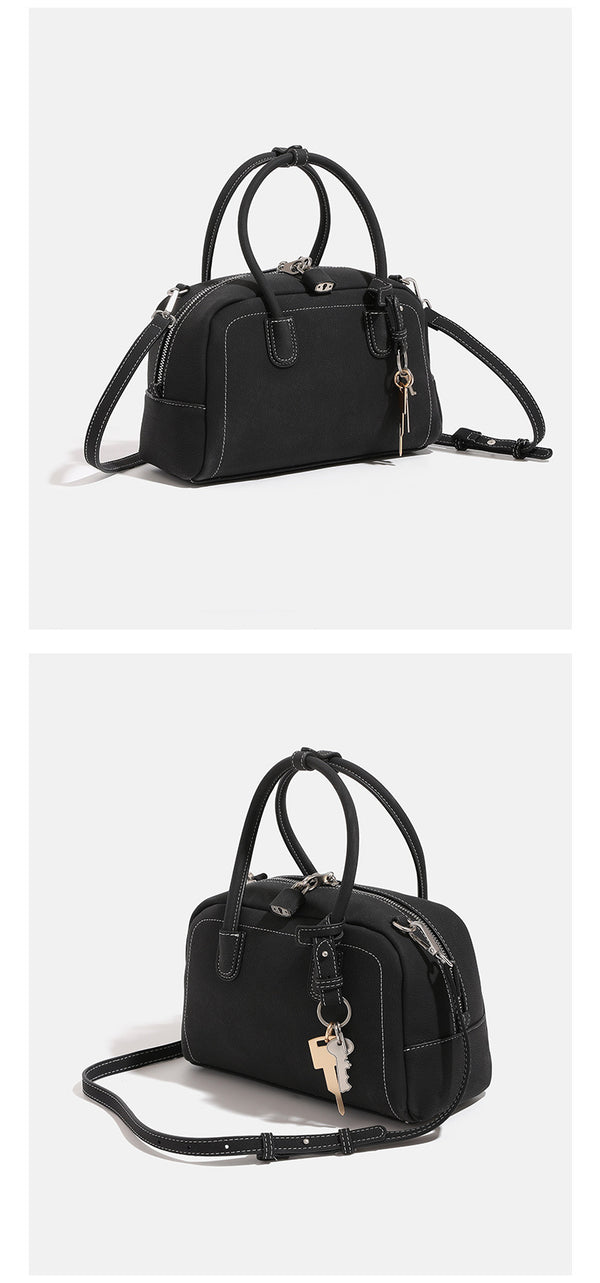 Compact retro Boston satchel bag with matte suede-look finish, twin rounded top handles, double zip closure with silver-tone