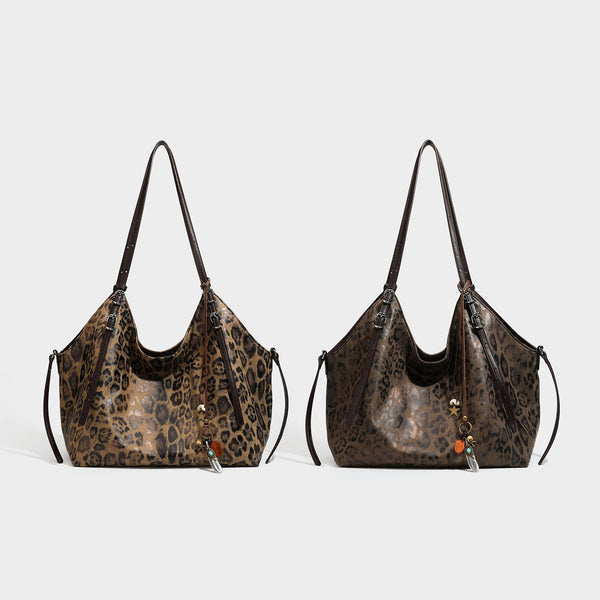 Slouchy leopard-print shoulder tote bag in tan and brown with long double straps, side tie straps, and dangling charm, detail