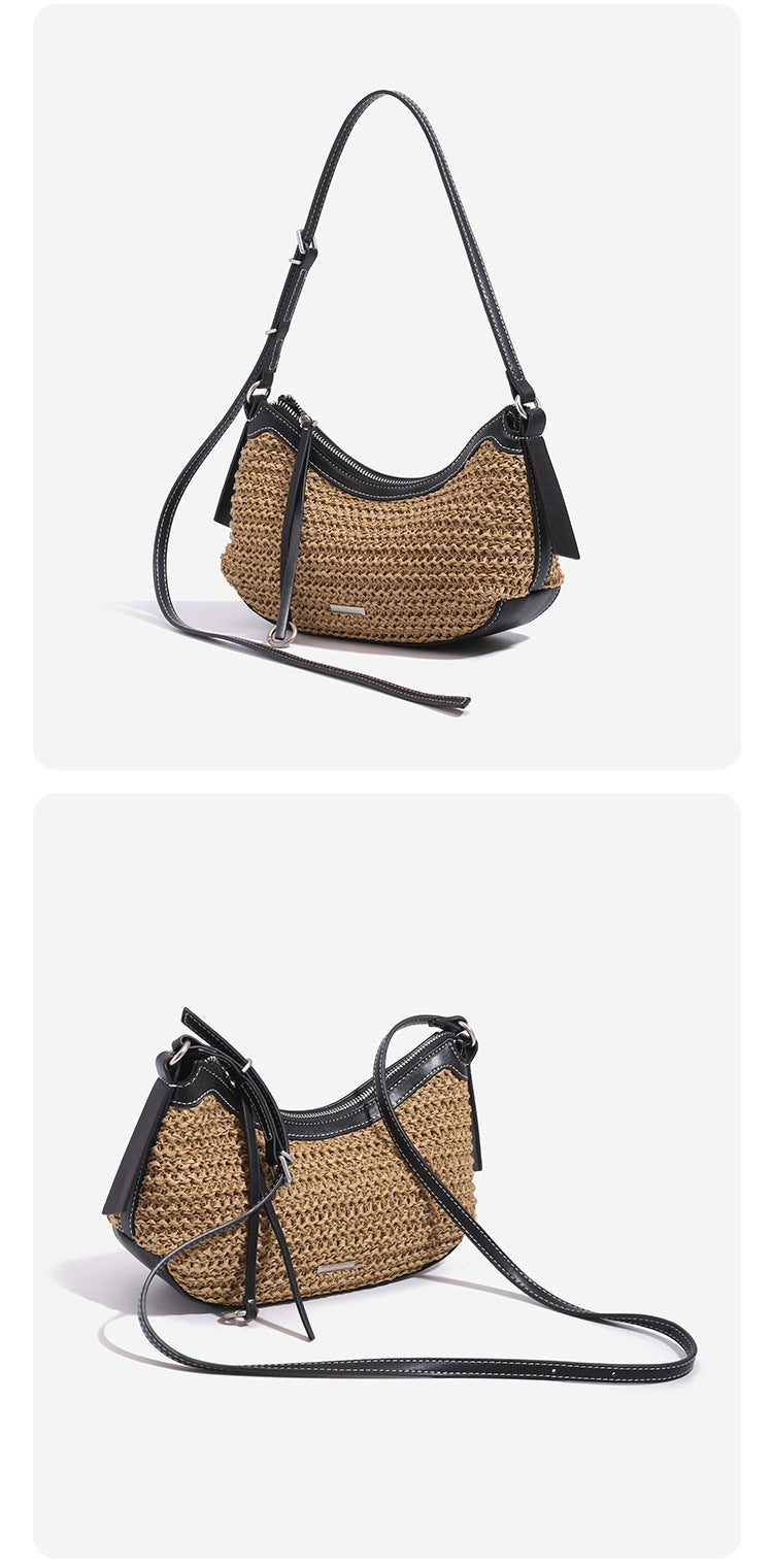 Tan woven straw half-moon shoulder bag with black leather-look trim, zip closure, tassel pull, and adjustable crossbody