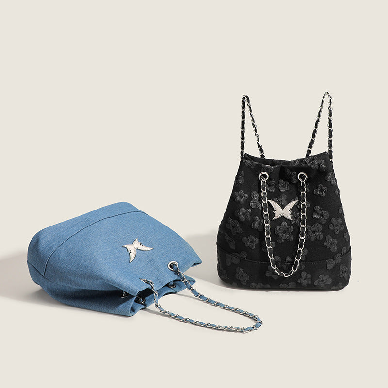 Floral jacquard bucket bag with silver-tone chain straps and swallow medallion hardware, detail view 2