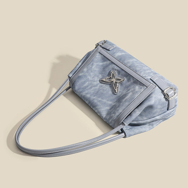 Washed leather-look shoulder tote bag with silver butterfly emblem and buckle hardware, detail view 4
