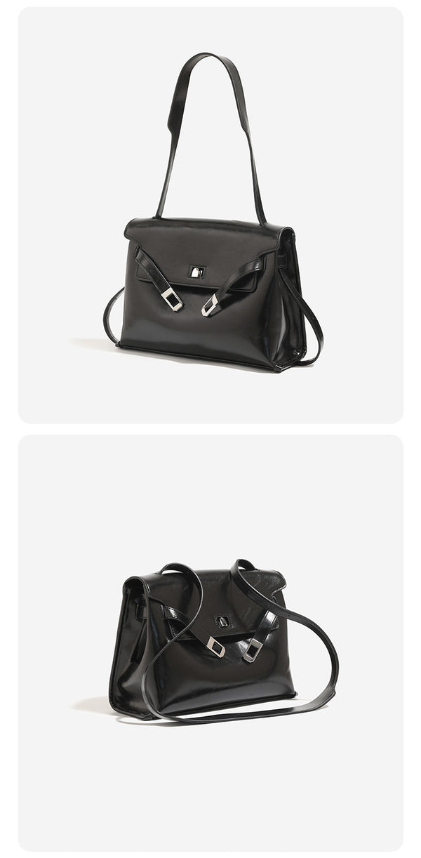 Structured trapezoidal flap satchel bag with silver-tone turn-lock clasp, decorative front strap tabs, gusseted sides, and