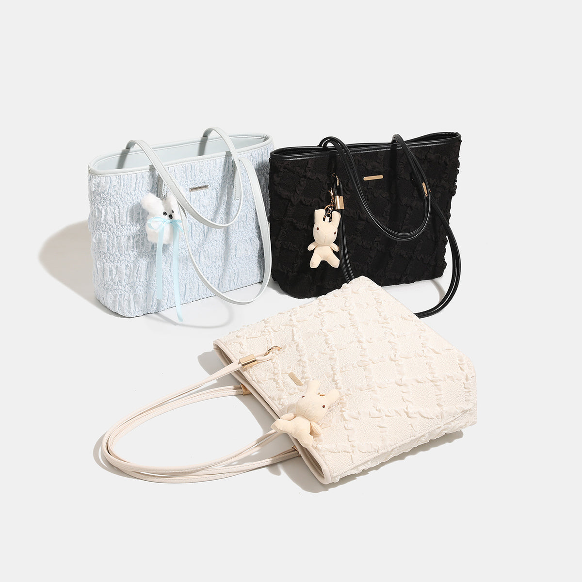 Large structured ruffled textile tote bag with gold-tone hardware and plush bunny charm, detail view 2