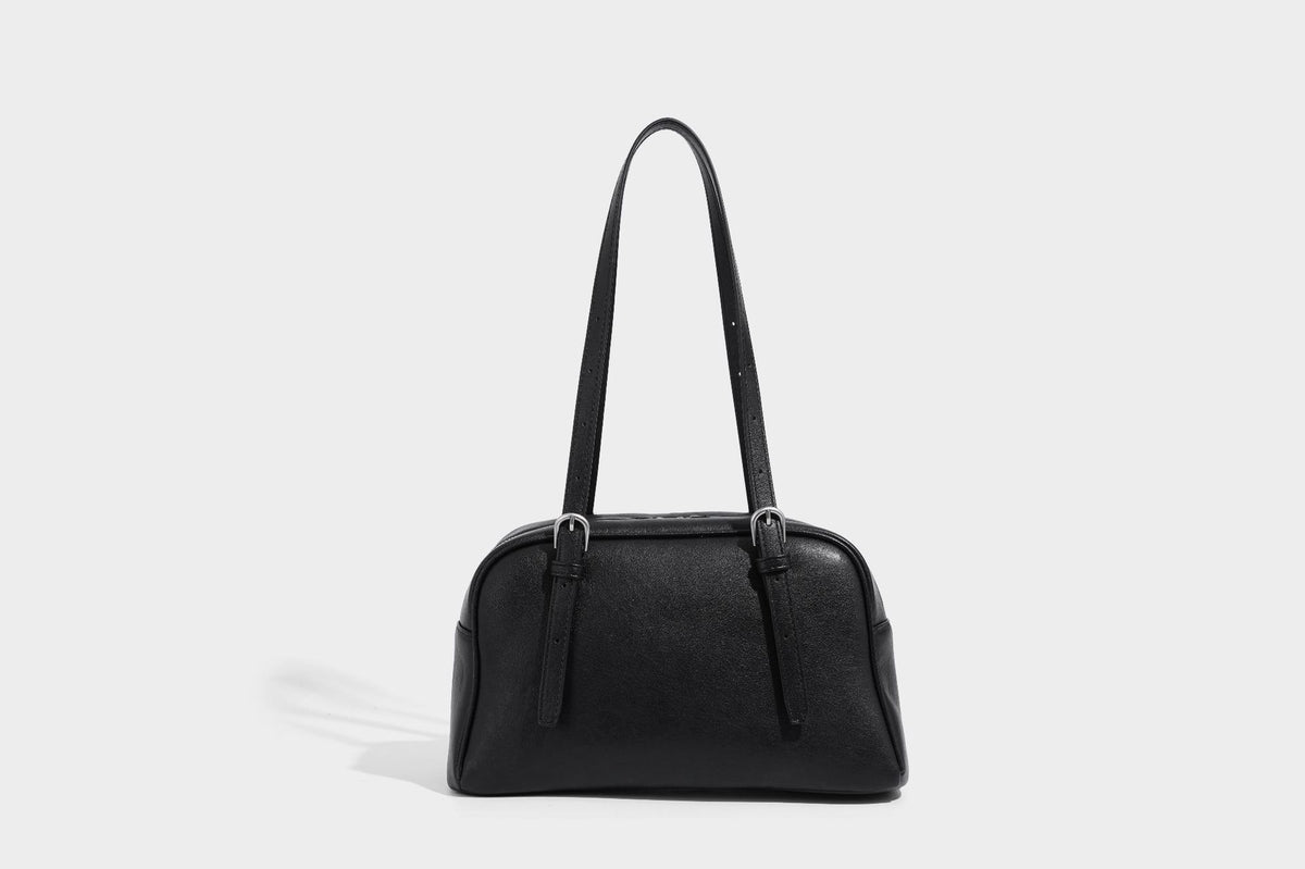 Structured dome-shaped shoulder bag with leather-look finish, top zipper closure, dual adjustable slim straps, and, detail