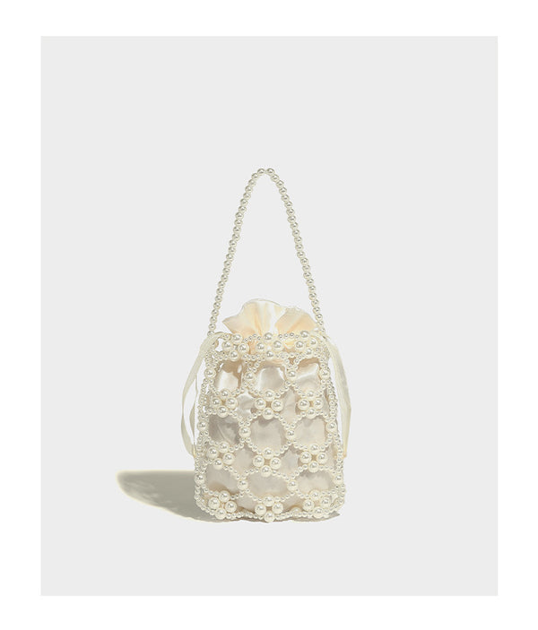 Small pearl-beaded lattice drawstring bucket bag with beaded shoulder strap and ribbon closure, detail view 9