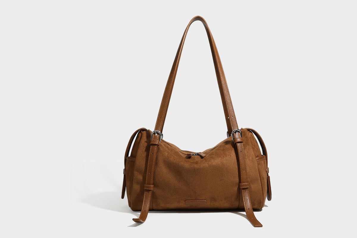 Large brown suede-finish barrel shoulder bag with dark leather-look trim, silver-tone zippers, dual top handles, and long
