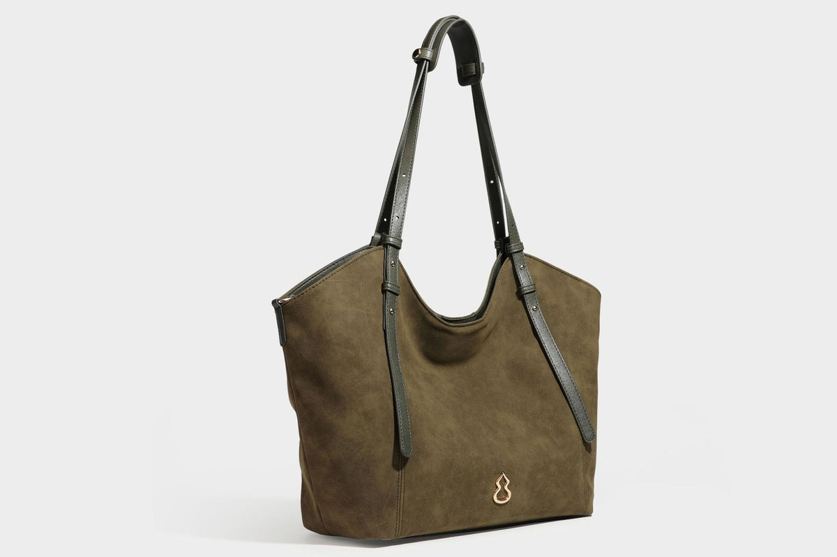 Oversized suede-finish tote shoulder bag in caramel brown with slim leather-look straps and gold-tone logo hardware, detail