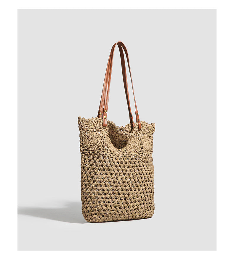 Woven crochet shoulder tote bag with scalloped floral top edge, tan leather-look straps, and antique gold rivets, detail view
