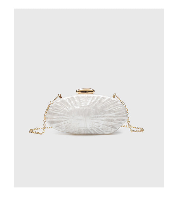 Oval pearl-finish shell clutch bag with gold-tone clasp and removable gold link chain strap, detail view 8