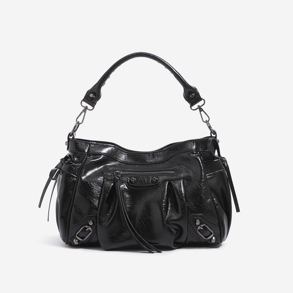 Slouchy glossy crinkle leather-look shoulder bag with silver stud accents, tassel ties, front zip pocket, and top handle