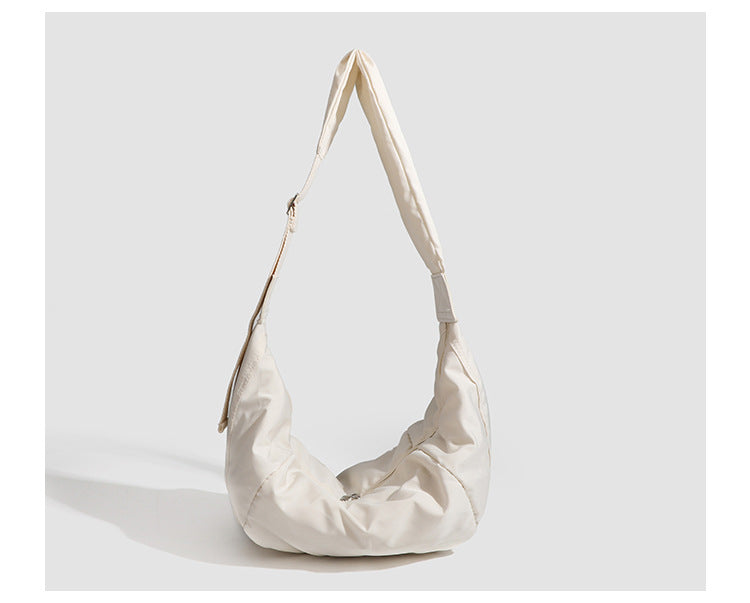 Large crescent sling shoulder bag in gathered fabric with zip closure and adjustable strap, detail view 11