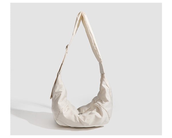 Large crescent sling shoulder bag in gathered fabric with zip closure and adjustable strap, detail view 11