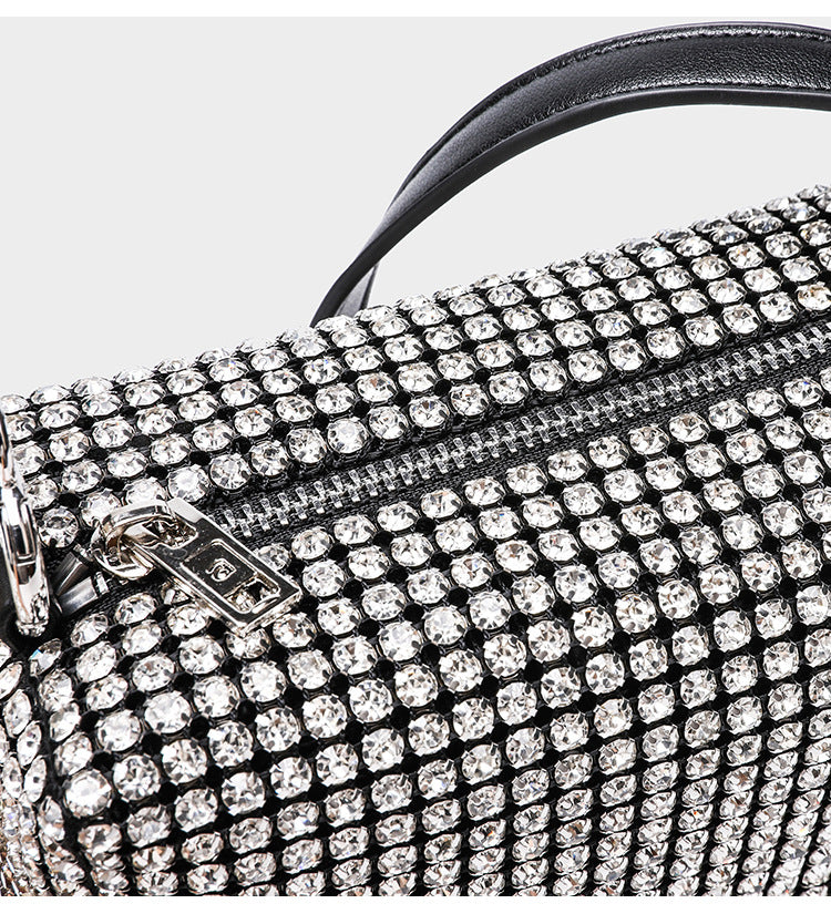 Small rectangular all-over rhinestone crossbody bag with pearl bead zipper pull and detachable silver chain strap, detail