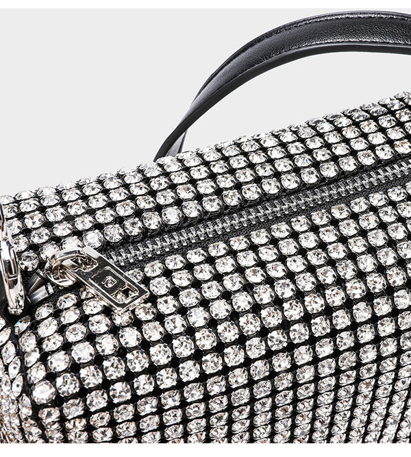 Small rectangular all-over rhinestone crossbody bag with pearl bead zipper pull and detachable silver chain strap, detail
