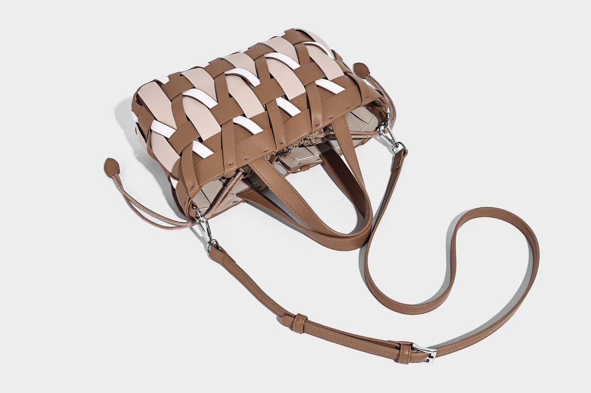 Small structured woven lattice tote bag with dual top handles and detachable shoulder strap in brown and cream leather-look