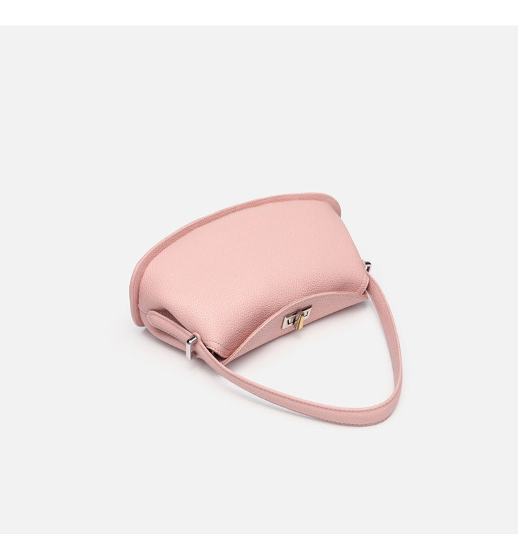 Pebbled leather-look half-moon saddle bag with turn-lock flap closure, top handle, and detachable crossbody strap, detail