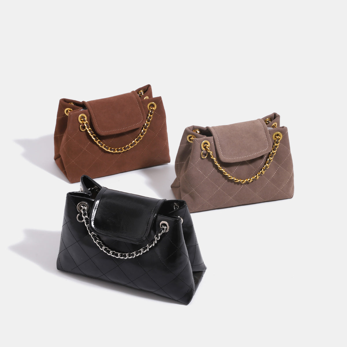 Quilted trapezoid shoulder bag with chain straps, flap closure, and ring hardware, detail view 2
