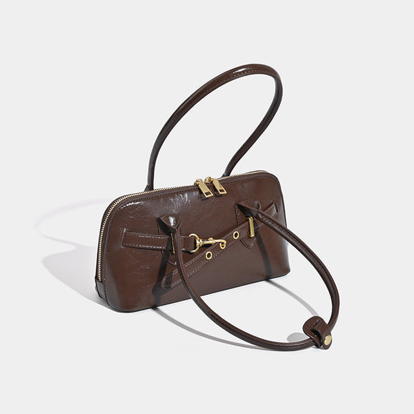 Small structured glossy leather-look shoulder bag with gold-tone buckle hardware and twin top handles, detail view 3