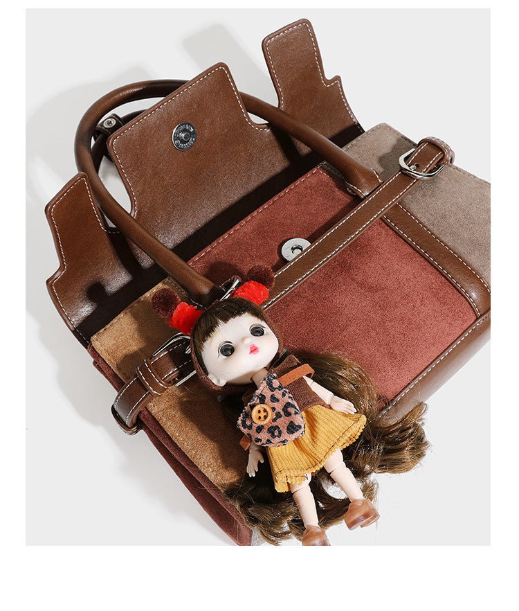 Structured color-block satchel bag in brown, rust, beige, and taupe suede-look panels with white topstitching, front buckle