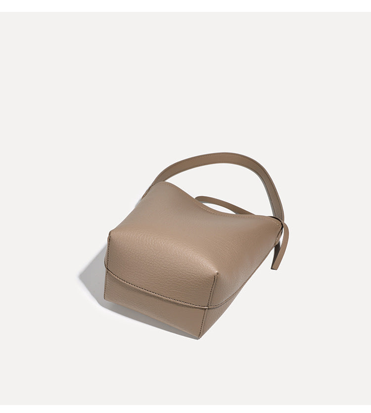 Mini tapered bucket bag in pebbled leather-look finish with front tie straps and single shoulder strap, detail view 13