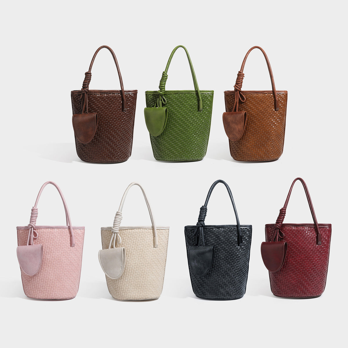 Structured woven-texture leather-look bucket bag in brown with knotted top handles, small front flap pouch, and adjustable