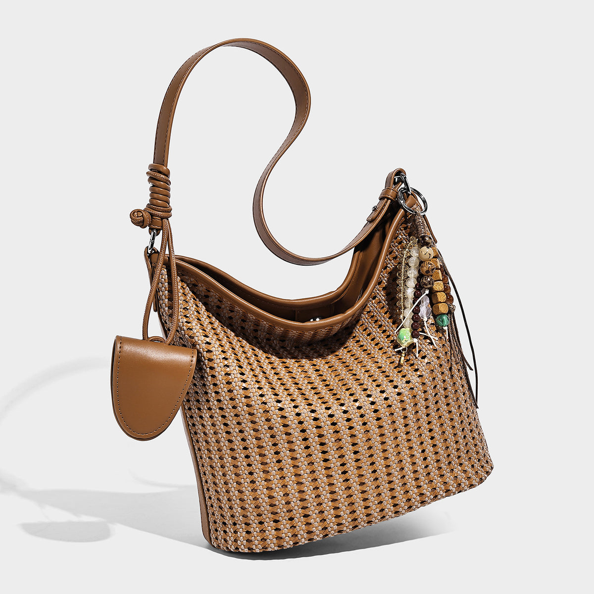 Slouchy open-weave hobo shoulder bag with leather-look trim, beaded tassel charm, and adjustable strap, detail view 7