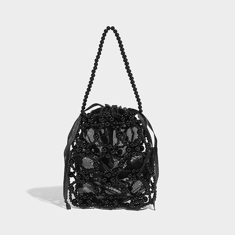 Small pearl-beaded lattice drawstring bucket bag with beaded shoulder strap and ribbon closure, detail view 7