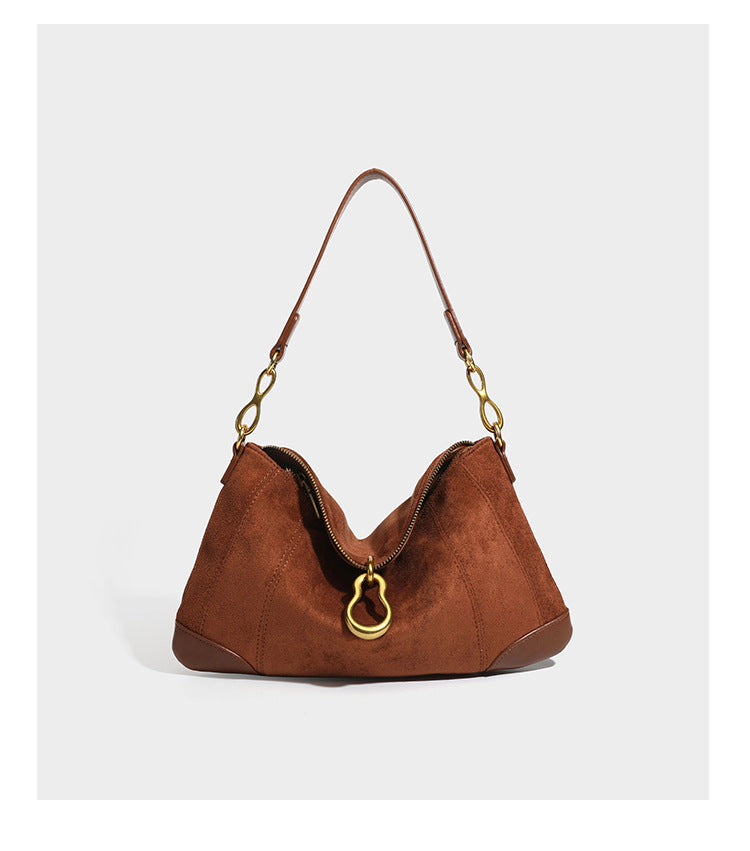 Slouchy denim shoulder bag with dark leather-look trim, gold-tone chain-link hardware, and top zipper closure, detail view 15