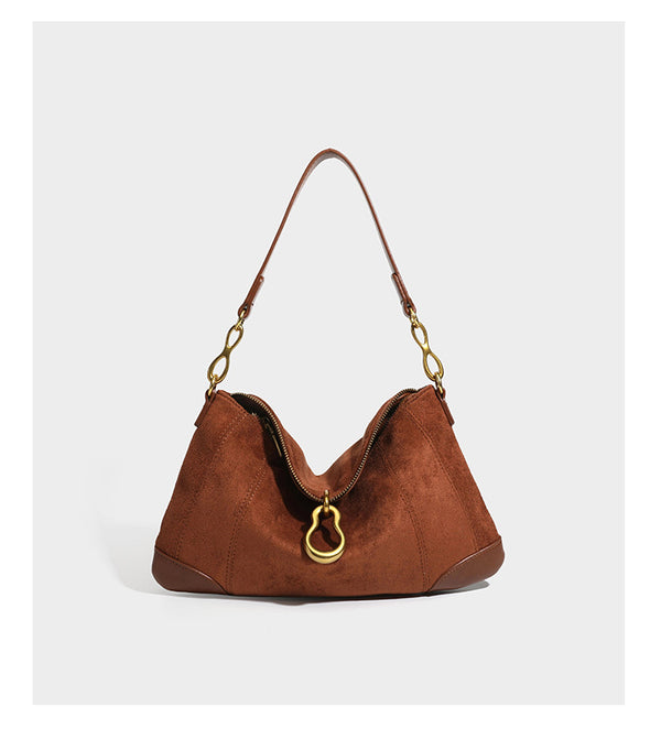 Slouchy denim shoulder bag with dark leather-look trim, gold-tone chain-link hardware, and top zipper closure, detail view 15