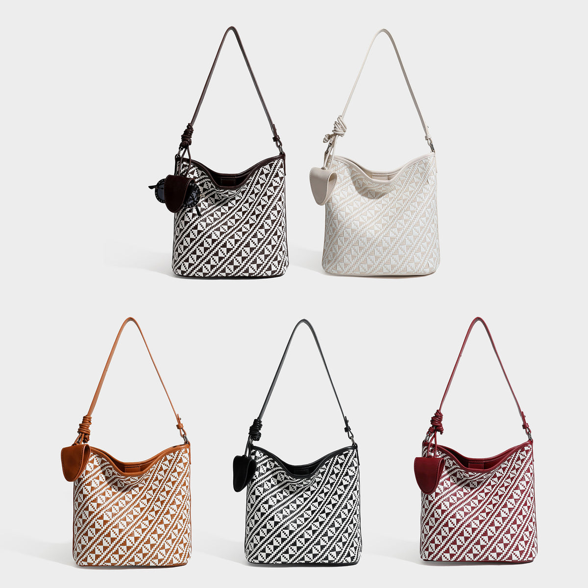 Woven geometric tribal-pattern shoulder bag with dark brown leather-look trim, long adjustable strap, and small hanging zip