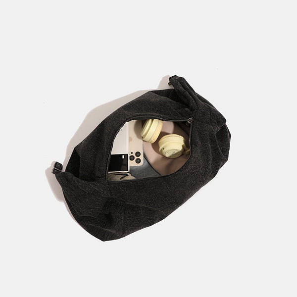 Oversized slouchy hobo shoulder bag in dark marled denim-texture fabric with top zip closure and adjustable single strap