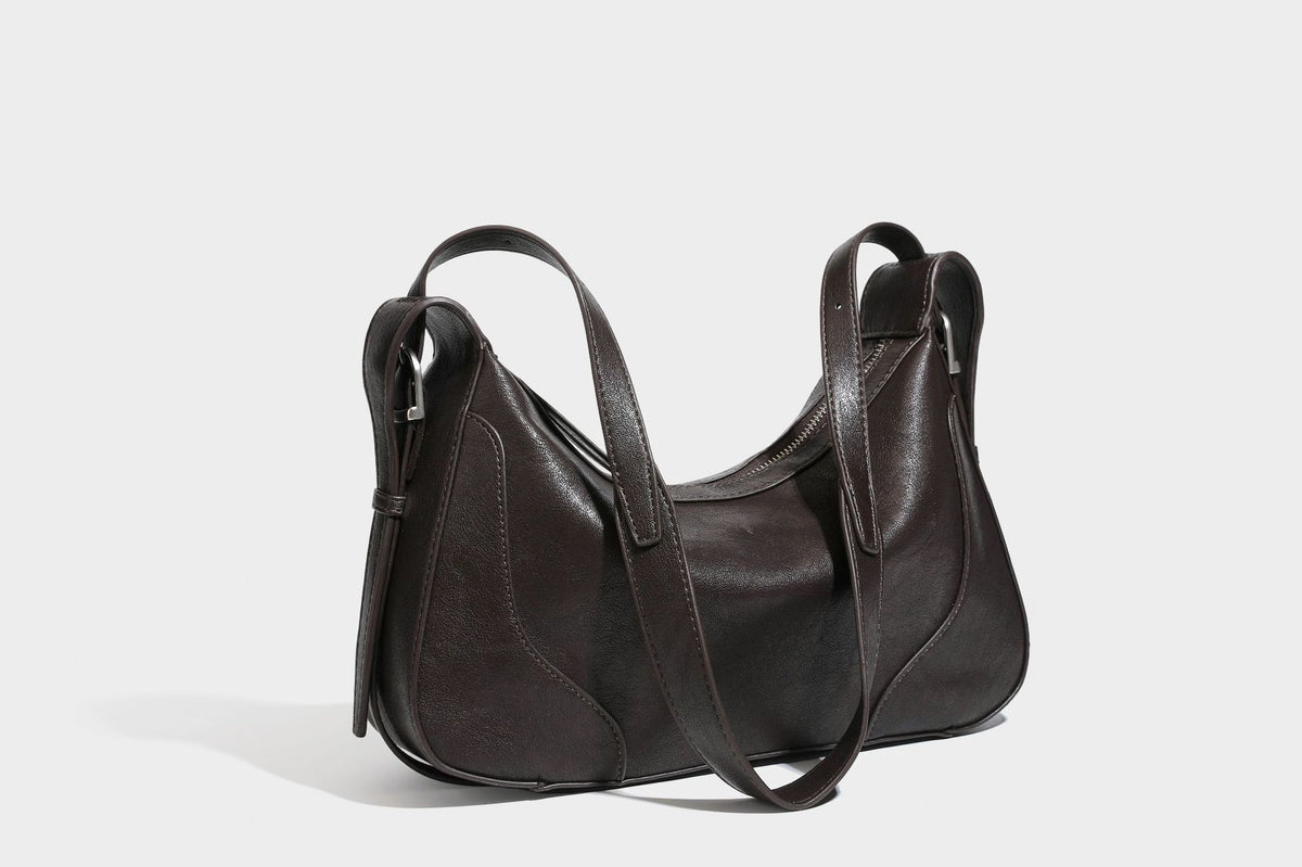 Slouchy crescent hobo shoulder bag in dark brown pebbled leather-look finish with zip top and long shoulder strap, detail