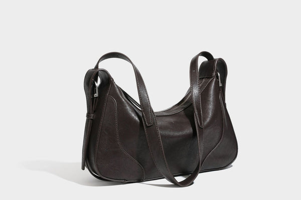 Slouchy crescent hobo shoulder bag in dark brown pebbled leather-look finish with zip top and long shoulder strap, detail
