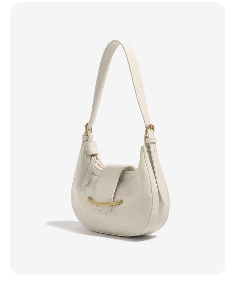 Compact crescent hobo shoulder bag with glossy synthetic finish, curved gold-tone front bar hardware, zip-top closure, and