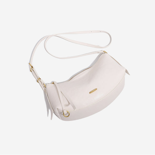 Compact soft rounded zip-top shoulder bag with gold-tone hardware and adjustable crossbody strap, detail view 4