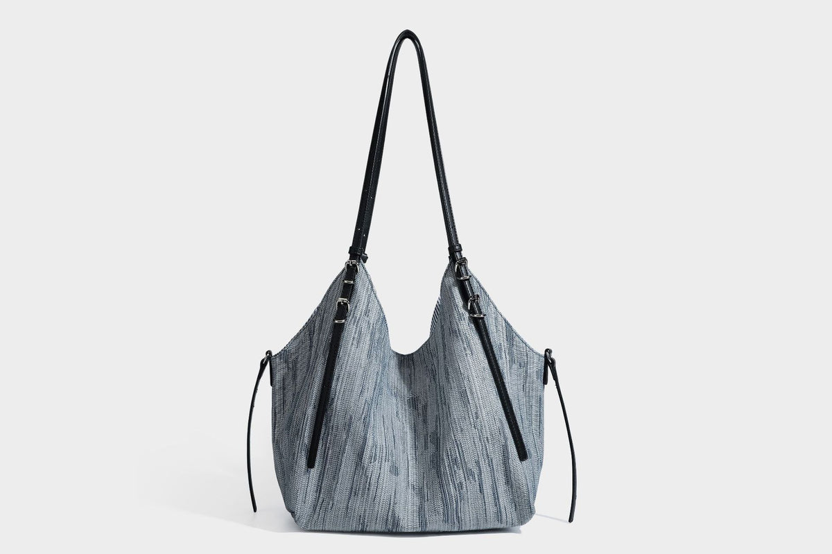 Large slouchy woven-texture shoulder tote bag with slim leather-look straps, side cinch ties, and silver-tone hardware