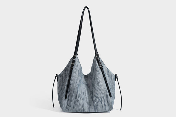 Large slouchy woven-texture shoulder tote bag with slim leather-look straps, side cinch ties, and silver-tone hardware