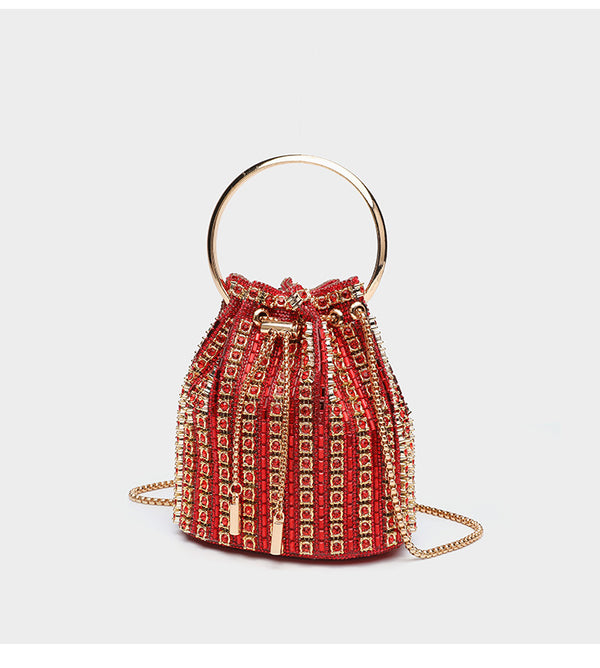 Mini crystal rhinestone bucket bag with circular ring top handle, drawstring closure, and silver chain shoulder strap, detail