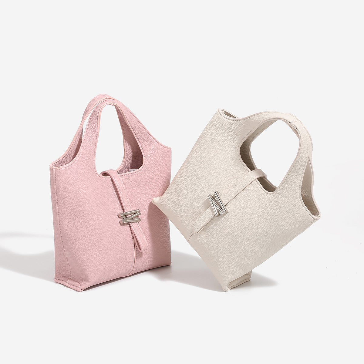 Mini pebbled leather-look bucket tote with silver toggle clasp and dual top handles, front view