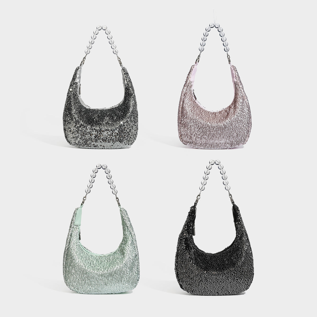 Small crescent shoulder bag with all-over silver sequin exterior, clear spherical bead top handle, and silver-tone zip