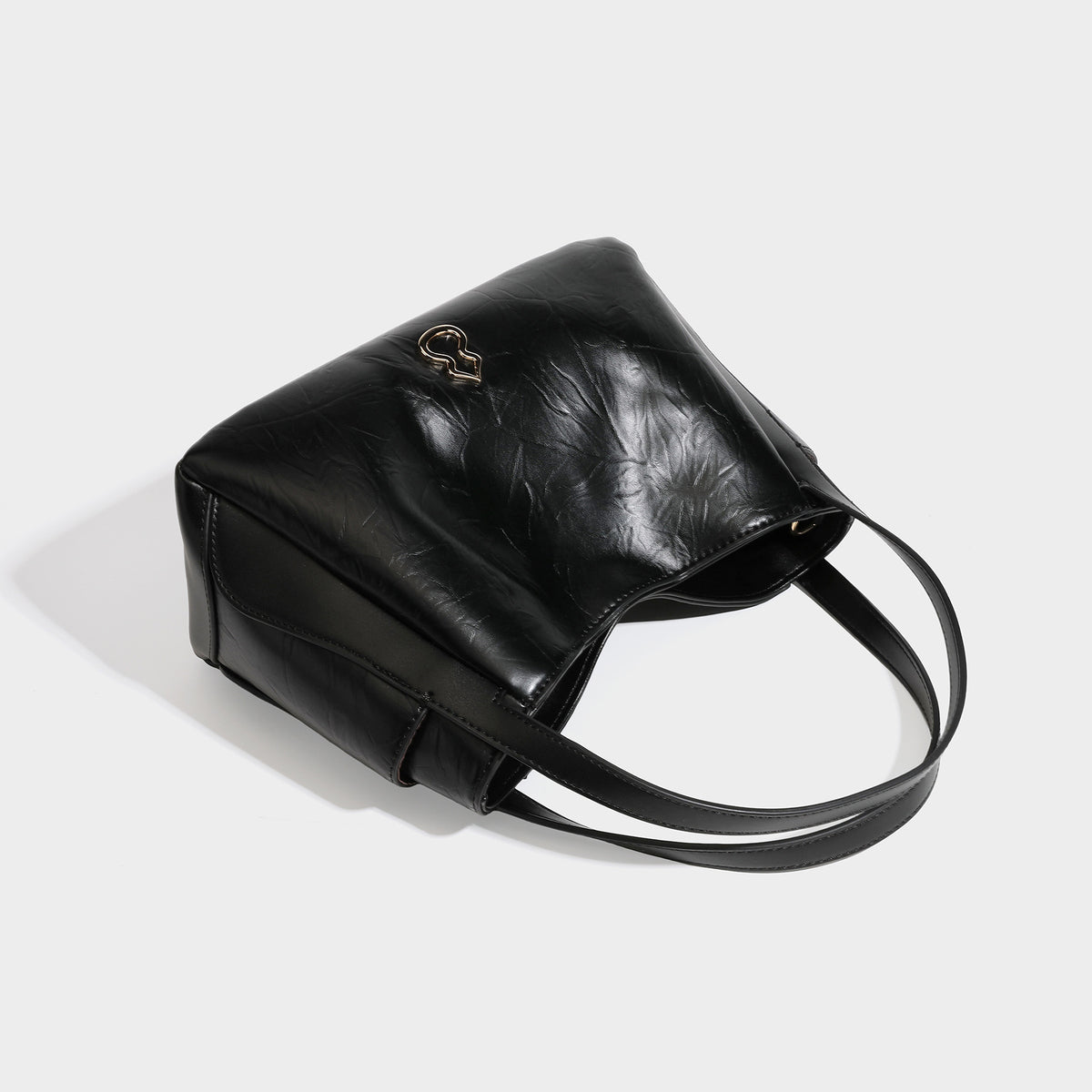Black glossy crinkled leather-look convertible shoulder tote bag with gold gourd-shaped emblem hardware and detachable