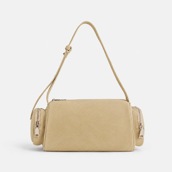 Mini barrel shoulder bag with side zip pouches and adjustable strap in pink suede-like finish, detail view 4