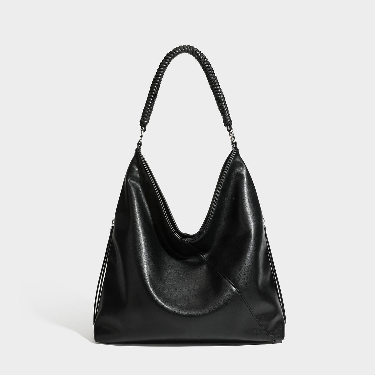 Large slouchy hobo shoulder bag with braided top handle, smooth glossy leather-look finish, and silver-tone ring hardware