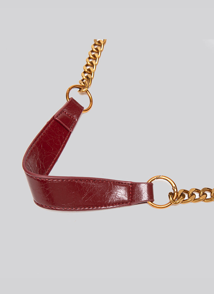 Glossy leather-look hobo shoulder bag with gold-tone chain-and-leather strap in deep burgundy red, detail view 16