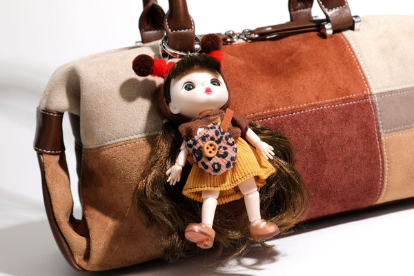 Patchwork suede-look barrel shoulder bag in brown, rust, tan, beige, and gray panels with double leather-look straps and