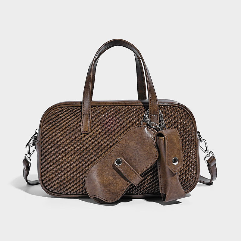 Structured woven-texture front top-handle handbag with zip closure, dual handles, detachable shoulder strap, and matching